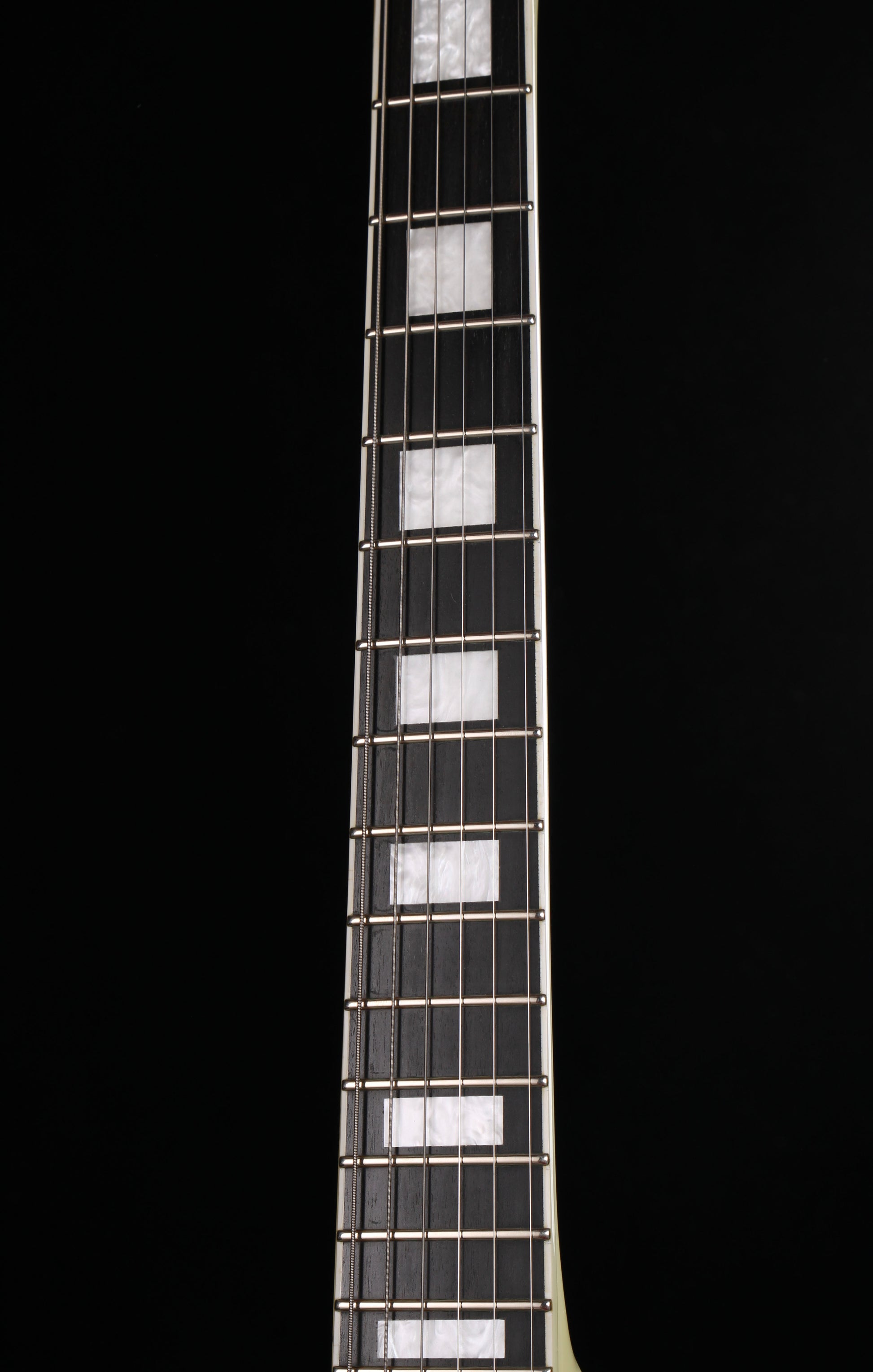 Edwards by ESP E-LP-130CD WH Les Paul Custom Antique White 2009 Seymour Duncan Pickups Close-up of a guitar neck with frets on a black background