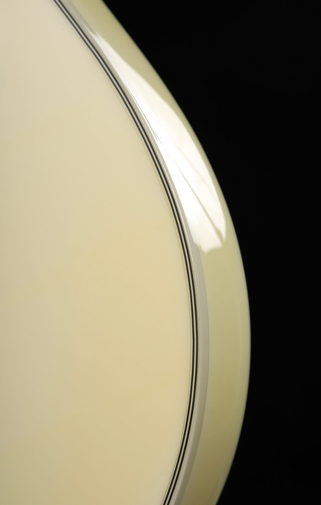 Edwards by ESP E-LP-130CD WH Les Paul Custom Antique White 2009 Seymour Duncan Pickups Close-up of a beige or light brown object with a reflective surface on a black background