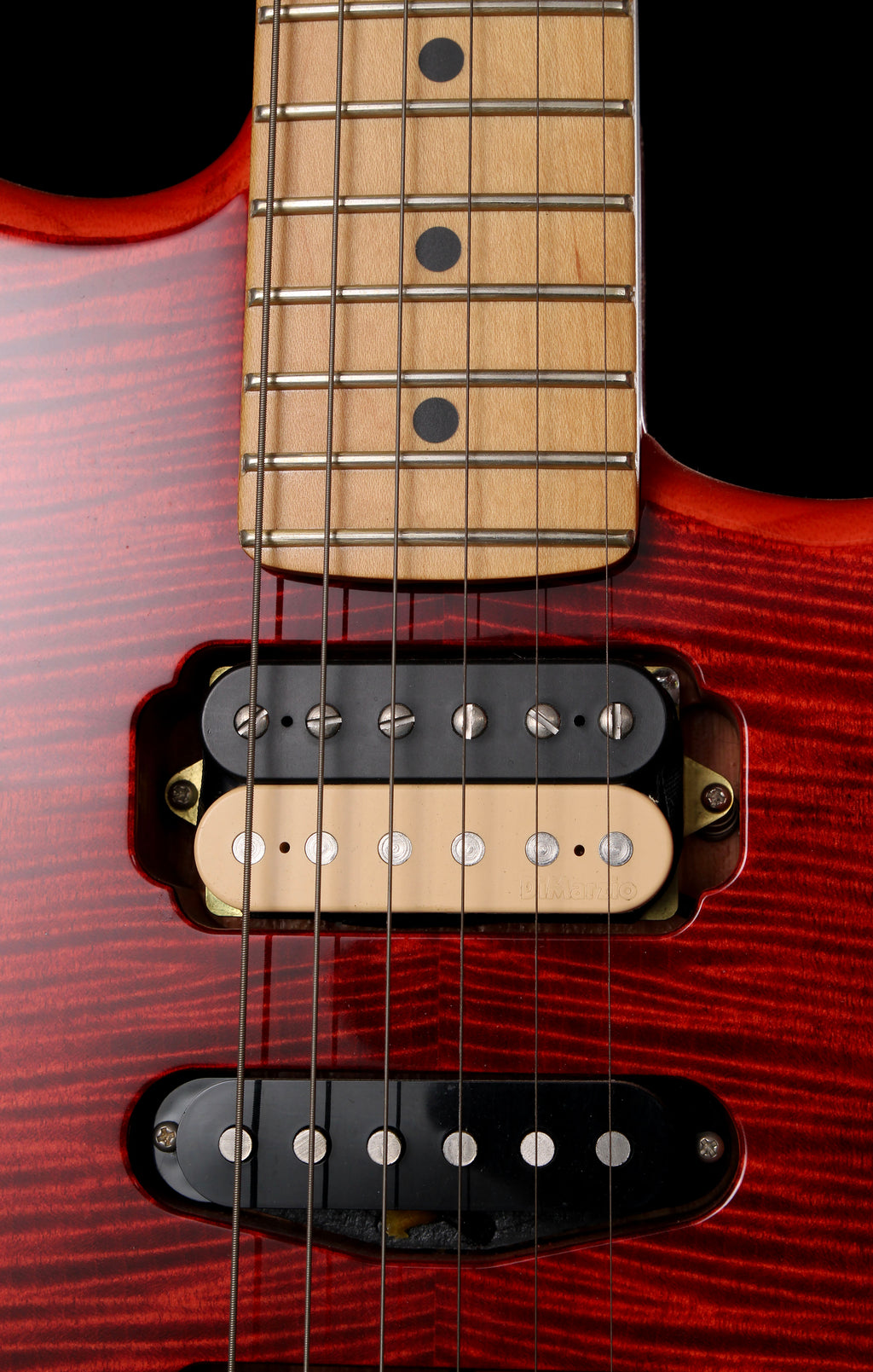 Fender Japan Michiya Haruhata Stratocaster Transparent Pink 2021: Close-up of an electric guitar body and neck showing a red cherry wood finish, maple fretboard, black and natural humbucker pickups, and metal tuning pegs.