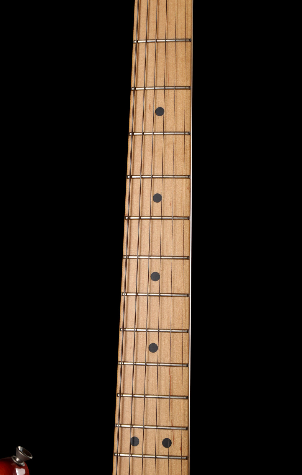 Fender Japan Michiya Haruhata Stratocaster Transparent Pink 2021: Close-up of a light natural wood guitar neck with six strings and black fretboard inlays against a solid black background.