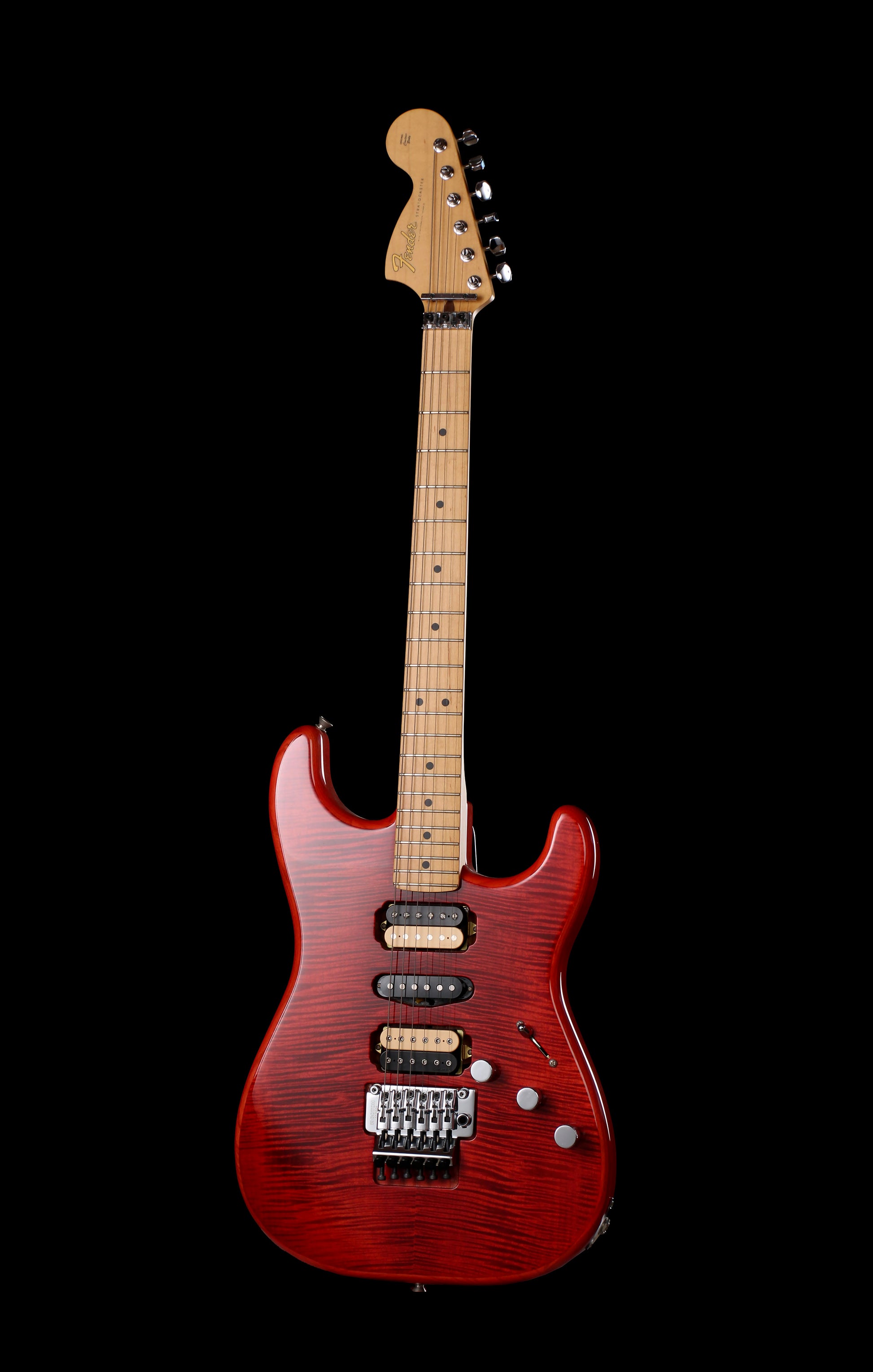 Fender Japan Michiya Haruhata Stratocaster Transparent Pink 2021: A red electric guitar with a natural wood neck and headstock, photographed against a solid black background.