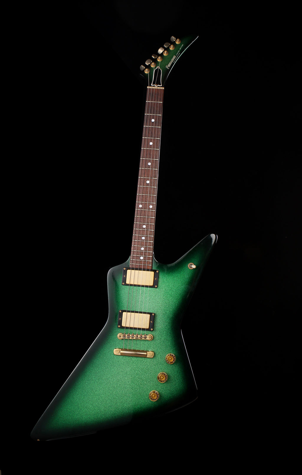 Fernandes EX Explorer Special Order SGS Sparkle Green Sunburst MIJ 1984: A green electric guitar with a distinctive angular body, gold hardware, and a dark brown neck, photographed against a solid black background.