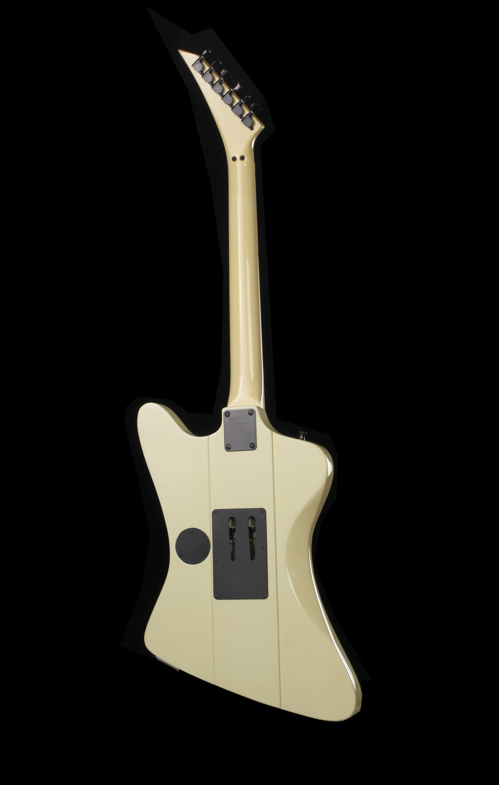 Fernandes FGJ-85RC Robbin Crosby Signature Firebird White 1986: The back view of a custom electric guitar with a cream-colored body and neck, featuring a black pickguard and control plate, set against a solid black background.